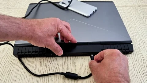Hands Connecting Power Cable to Metallic Gray Gaming Laptop Stock Footage 336708891