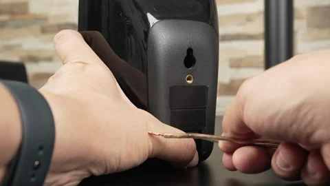 Hands Connecting Speaker Wire to Rear Terminals on Black Bookshelf Speaker Stock Footage 340550646