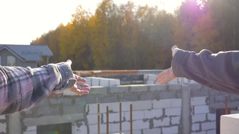 Hands of construction workers discussing and measuring distance on building site Stock Footage 316226641