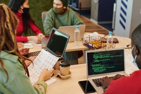 Hands of contemporary software developer using laptop while decoding information 스톡 사진