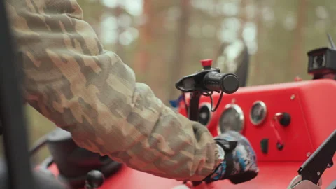 Hands control ATV ignition system. Operator engages throttle in rugged forest Stock Footage 334785026