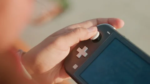 Hands control game. Closeup of fingers operating portable gaming device Stock Footage 333407916