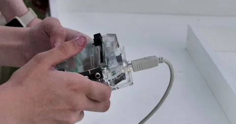 Hands control the robot car by remote control. Fingers press different buttons Stock Footage 277596616