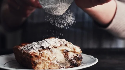 Hands of cook adding powdered sugar on the peice pie Stock-Footage 85850760