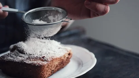 Hands of cook adding powdered sugar on the peice pie Stock Footage 85851295