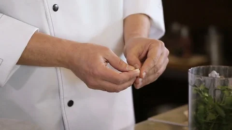 Hands of the cook cleaned garlic Video stock 74716014