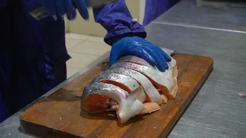 The hands of the cook cut the fish Stock Footage 148463053