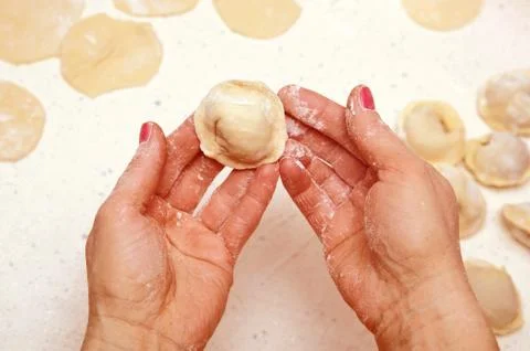 Hands of cook with dumplings Stock Photos
