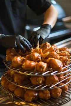 Hands cook in the frame correct chicken legs on the grill grill. Stock Photos