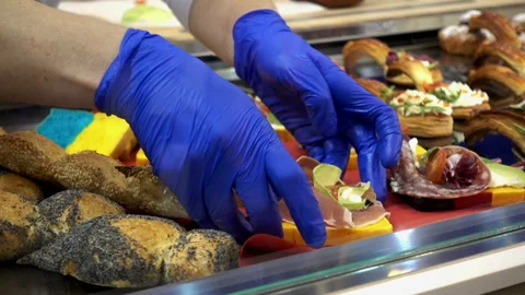 Hands of the cook lay out ready-made snacks on the counter. Stock Footage 92831736