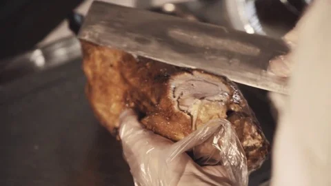 Hands of cooking chef carves chinese cusine roasted duck with big knife Stock Footage