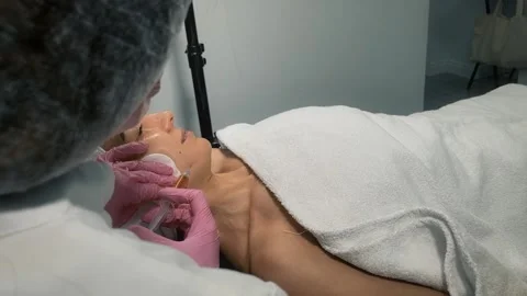 Hands of cosmetologist making injection in face Stock Footage 236722724