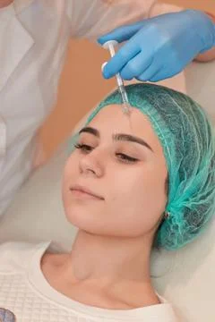 Hands of cosmetologist making injection in face Stock Photos