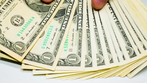 Hands count dollar banknotes. Male hands counting a stack of one-dollar US Stock Footage 246878304