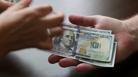 Hands count dollars and give it to another person, close-up. Exchange of Stock-Footage 336262686