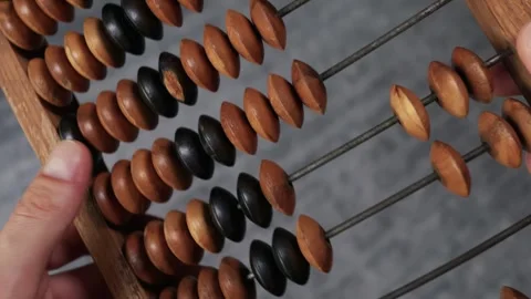 Hands Counting Beads on Classic Wooden Abacus for Math Calculations Stock Footage 339196007