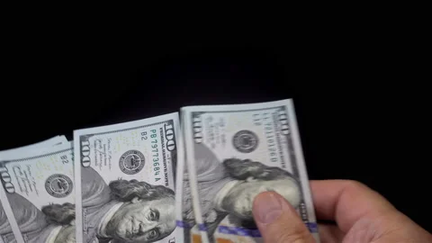 Hands counting bundle of dollar bills in 4K Stock Footage 139733904