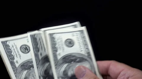 Hands counting bundle of hundred dollar bills in 4K Video stock 141324847