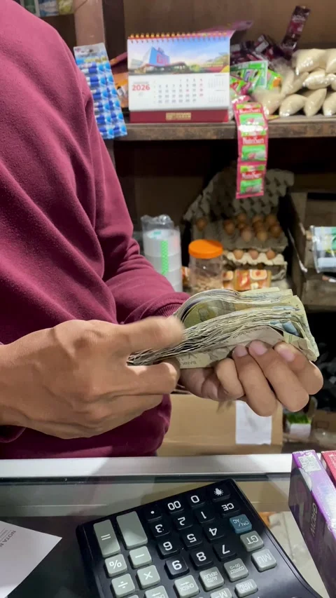 Hands Counting Cash at Small Local Shop Stock Footage 325634191