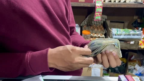Hands Counting Cash at Small Local Shop Stock Footage 325634192