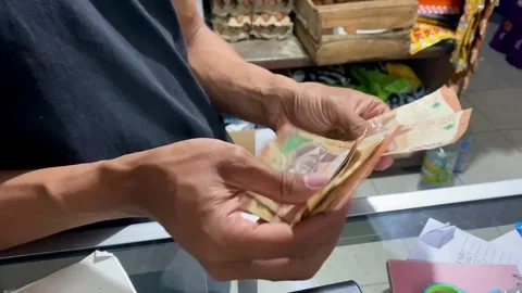 Hands Counting Cash at Store Counter Stock Footage 325092634