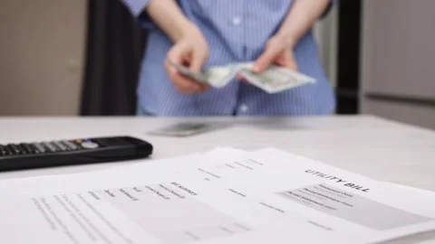 Hands counting cash with utility bills, economy and financial balance, elec.. Stock Footage 303214764
