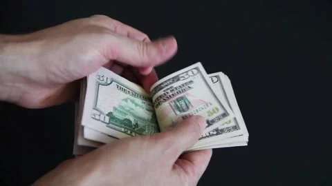 Hands counting dollar cash on black background. Concept of saving, planning 스톡 동영상 336263734