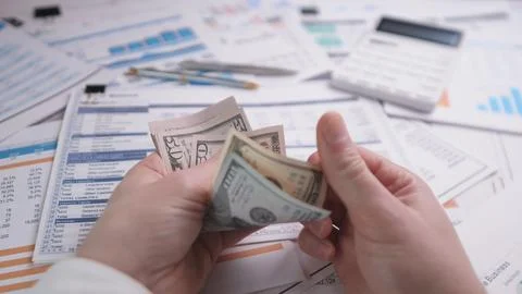 Hands counting dollars Stock Photos