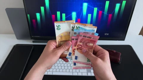 Hands Counting Euro Notes with Trading Screen Background Video stock 308287338