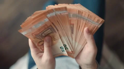 Hands counting euros, a close-up image highlighting finance and economy. Stock Footage 304814209