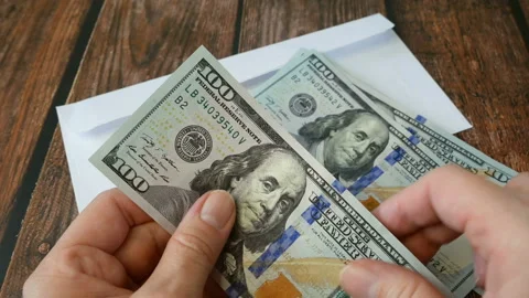 Hands is counting how much money in an envelope. money in envelopes for diffe Stock Footage 160810362