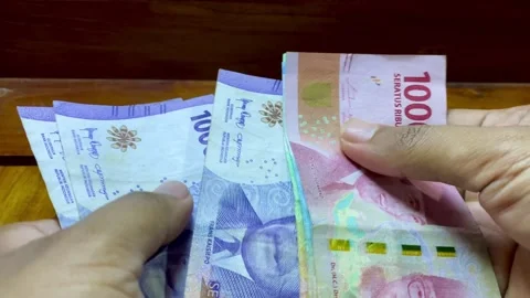 Hands Counting Indonesian Banknotes Close-Up Stock Footage 327348256