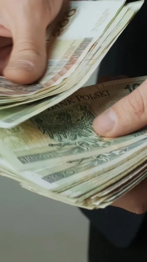 Hands counting a large stack of Polish Zloty banknotes. Cash and wealth. Stock Footage 331424568