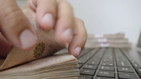 Hands counting a lot of thousands Thai baht banknotes money. Stock Footage 236016423