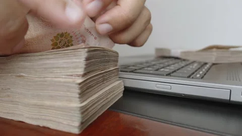 Hands counting a lot of thousands Thai baht banknotes money. Stock Footage 236018743