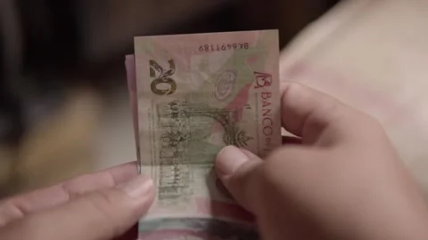 Hands counting Mexican peso banknotes showing fifty peso denominations in close Stock Footage 343710368