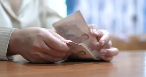 Hands counting money banknotes Thai baht on table, representing finance 스톡 동영상 336387836