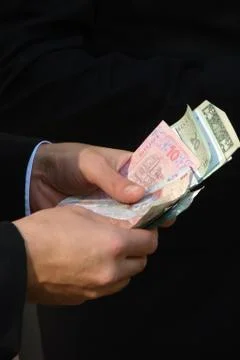Hands counting multicolored banknotes Stock Photos