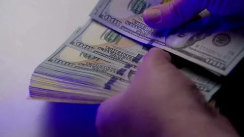 Hands counting out hundred dollar onto the table. Person calculates wages, .. Stock Footage 266474623