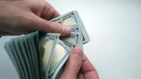 Hands counting stack of american hundred dollar bills on white background c.. Stock Footage 339758935