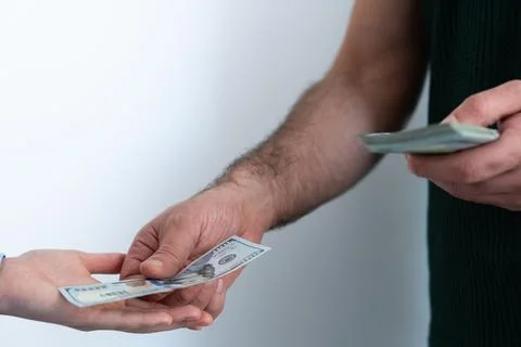 Hands counting stack of dollar bills Stock Photos