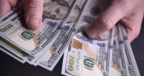 Hands counting a stack of hundred-dollar US banknotes Stock Footage 205041817