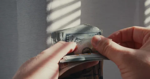 Hands counting a stack of hundred dollar bills Stock-Footage 347010152
