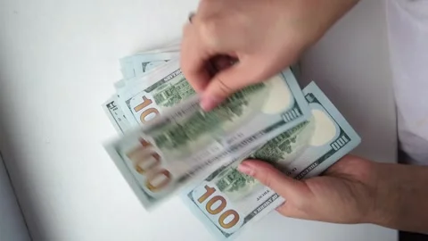 Hands counting stack of one hundred dollar bills on white surface during fi.. Stock Footage 339377092