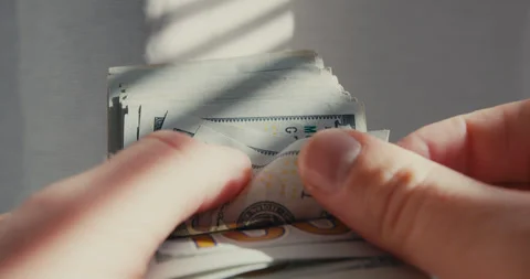 Hands counting a stack of one hundred dollar bills Video stock 347010190
