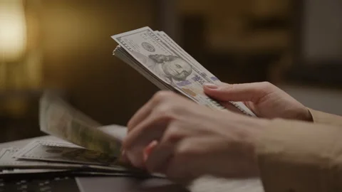 Hands counting a stack of US dollar bills Stock Footage 277137749