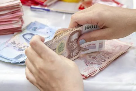 Hands counting of Thai baht notes money Stock Photos