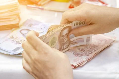 Hands counting of Thai baht notes money Stock Photos