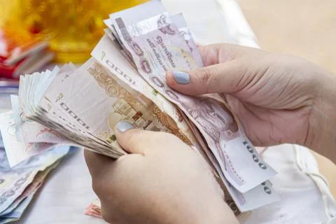 Hands counting of Thai baht notes money concept banknotes Stock Photos