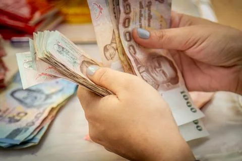 Hands counting of Thai baht notes money, banknotes paying Stock Photos